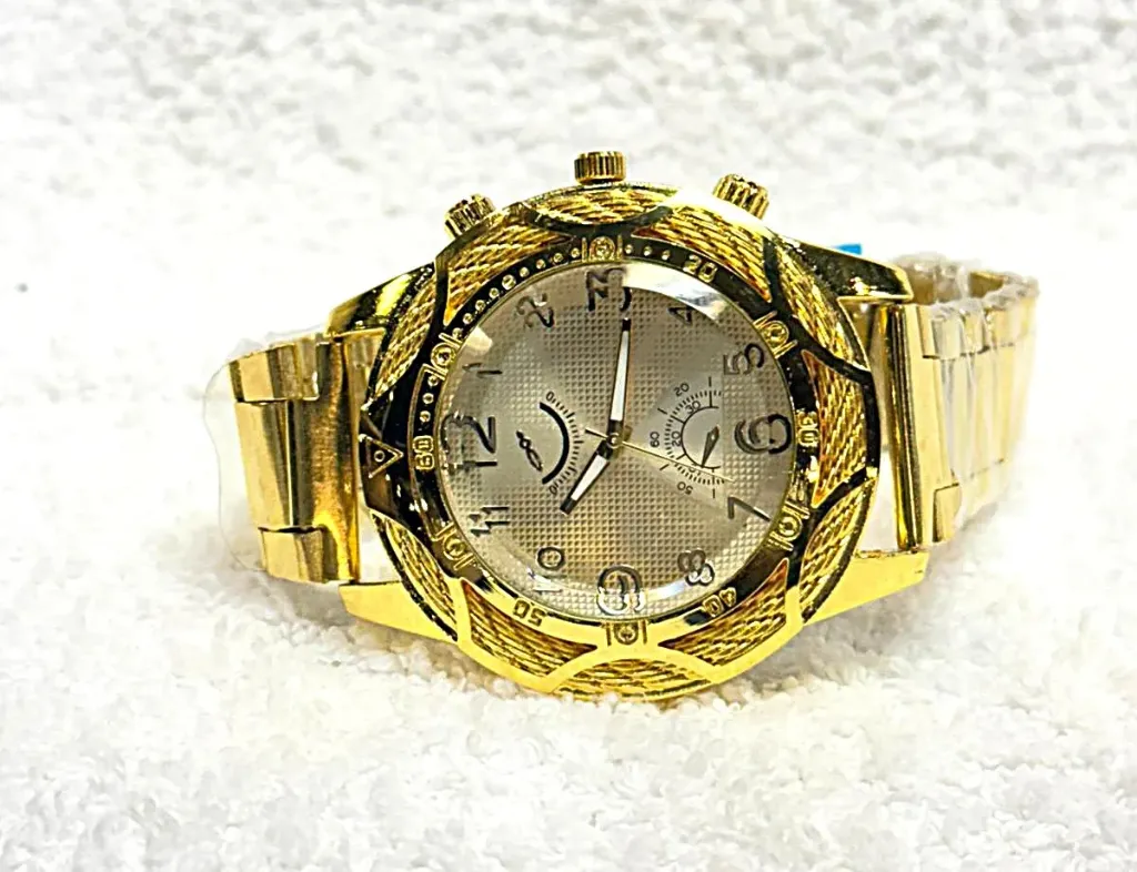 Gold wristwatch for men with a metal bracelet and a chronograph dial.